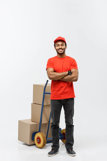 delivery-concept-portrait-handsome-african-american-delivery-man-courier-pushing-hand-truck-with-stack-boxes-isolated-grey-studio-background-copy-space_1258-1244